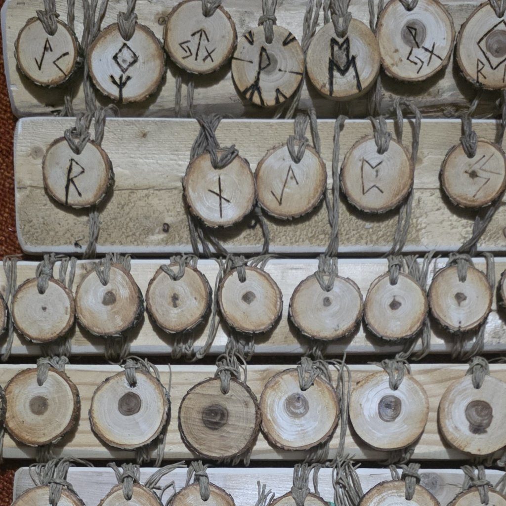 Driftwood rune pendants laid out in rows